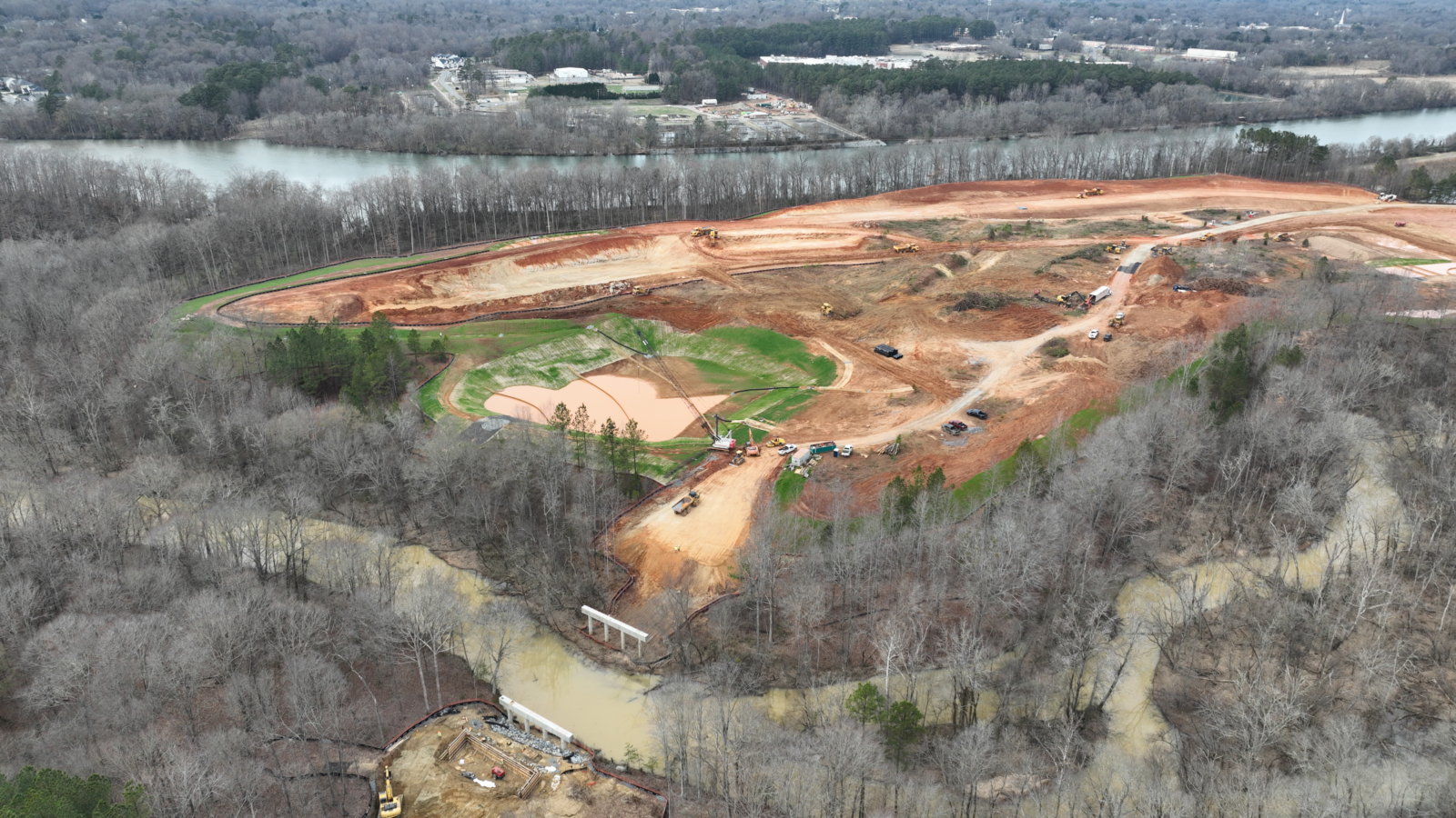 Aerial photography of a large construction site spanning several acres with the Catawba River in the background.