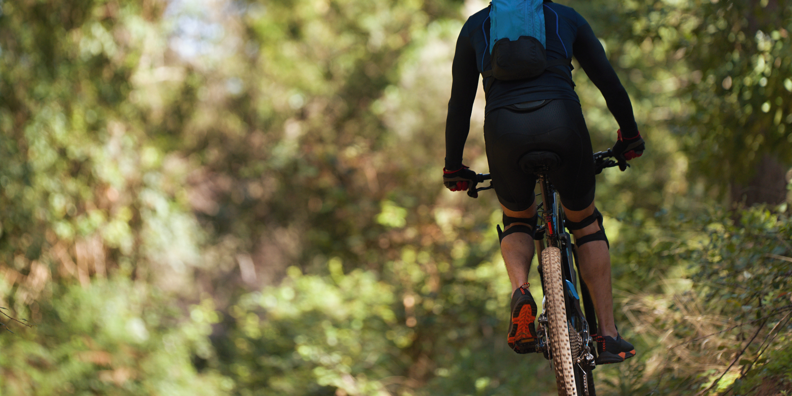 Mountain biking man riding on bike in summer mountains forest la Mountain biking man riding on bike in summer mountains forest la