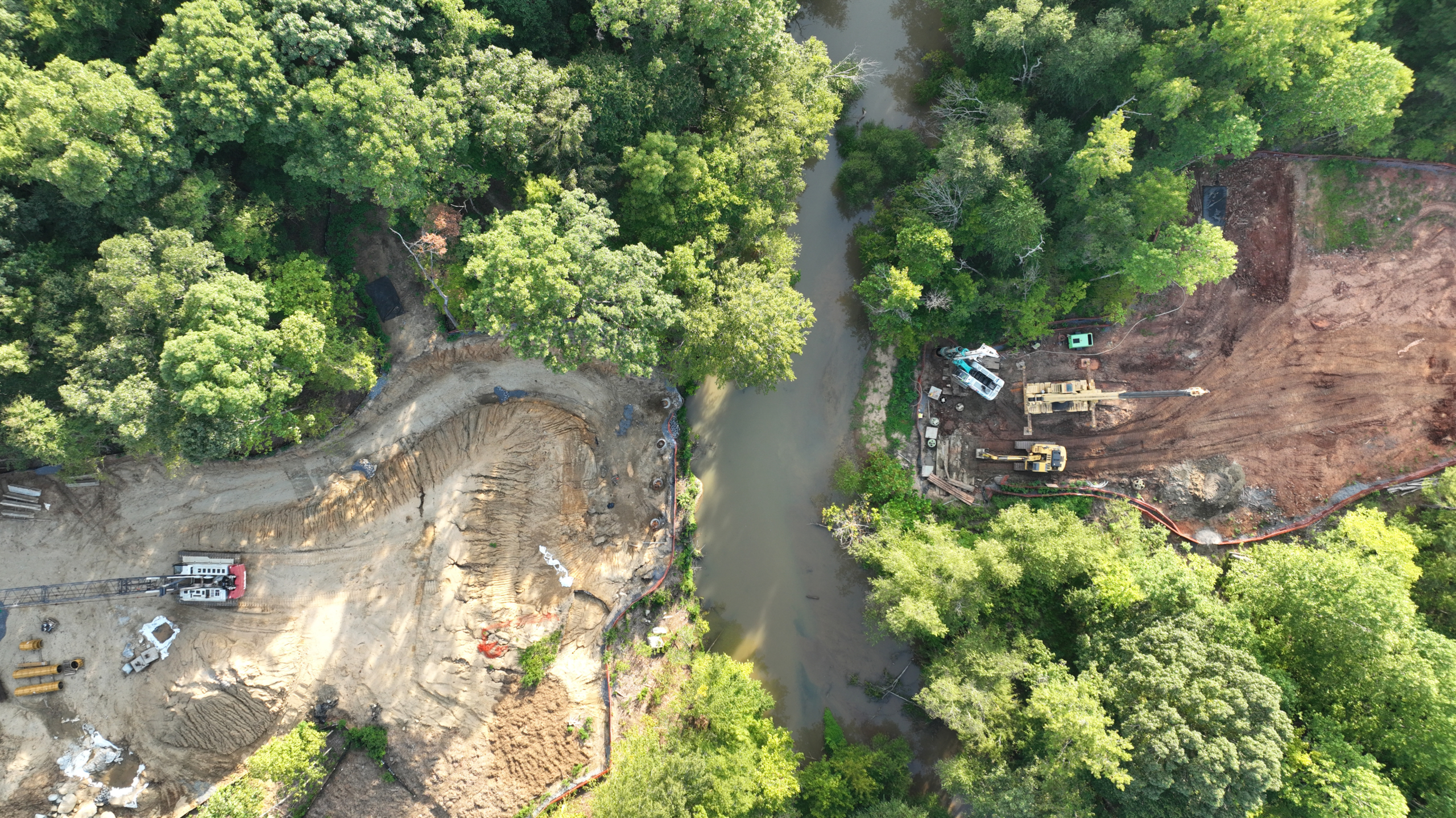 Aerial photograph of Long Creek with two construction sites on opposing banks.