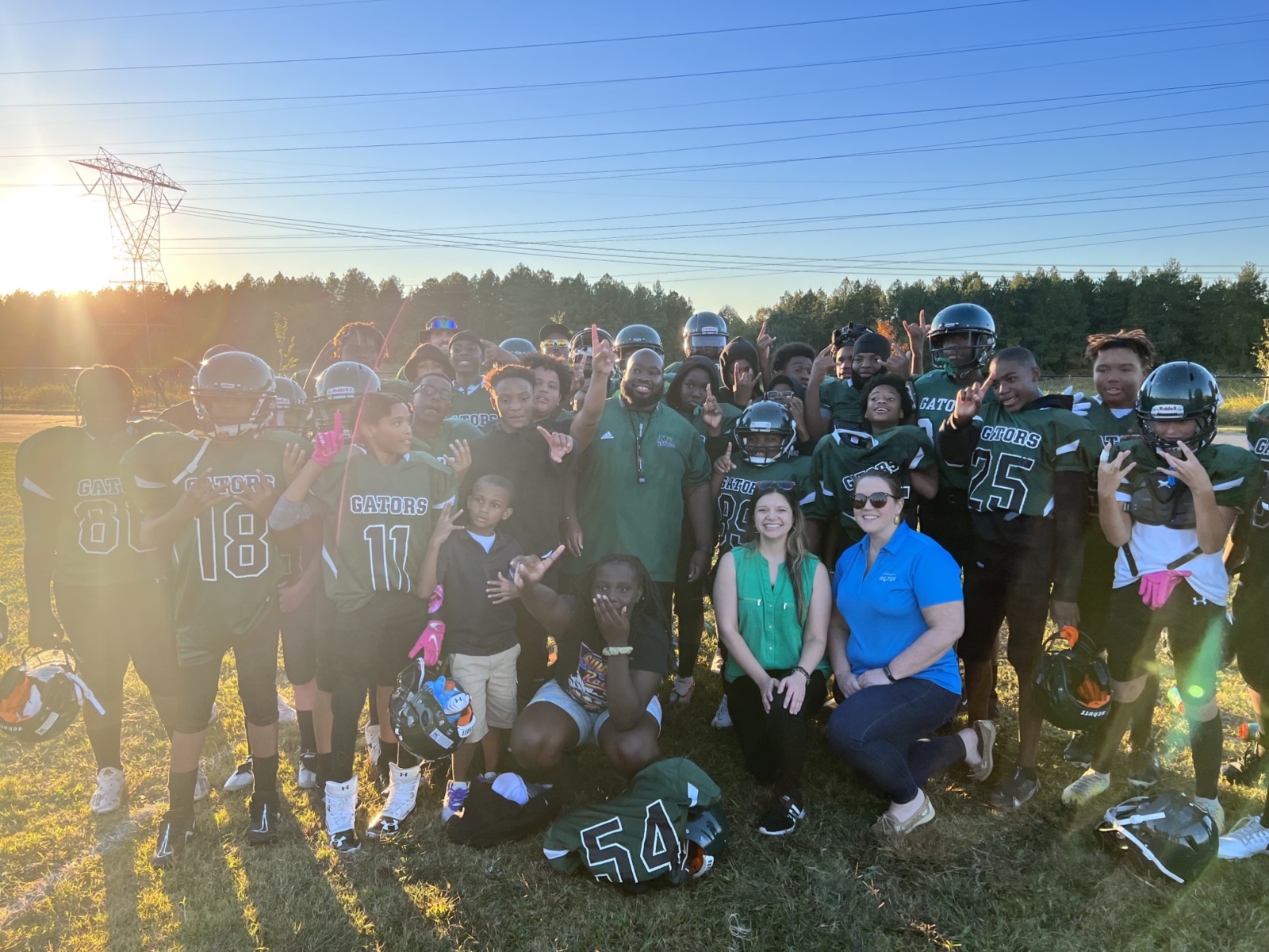 The Whitewater Middle School Football Team celebrate their win with Charlotte Water Project Manager Nicole Bartlett and Stowe Communications Manager Krystal Harwick