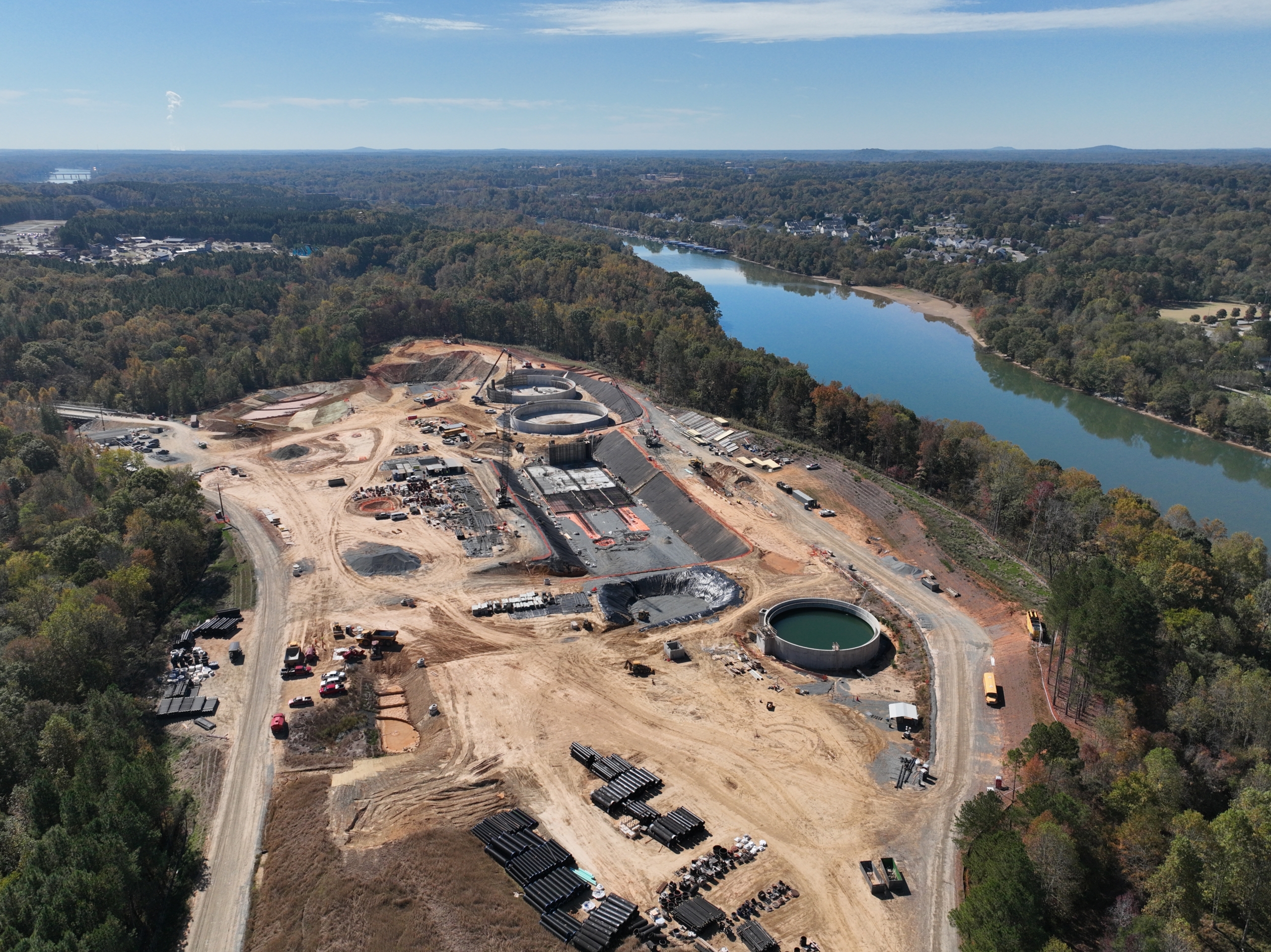 aerial drone photograph of a construction site surrounded by trees next to the Catawba River