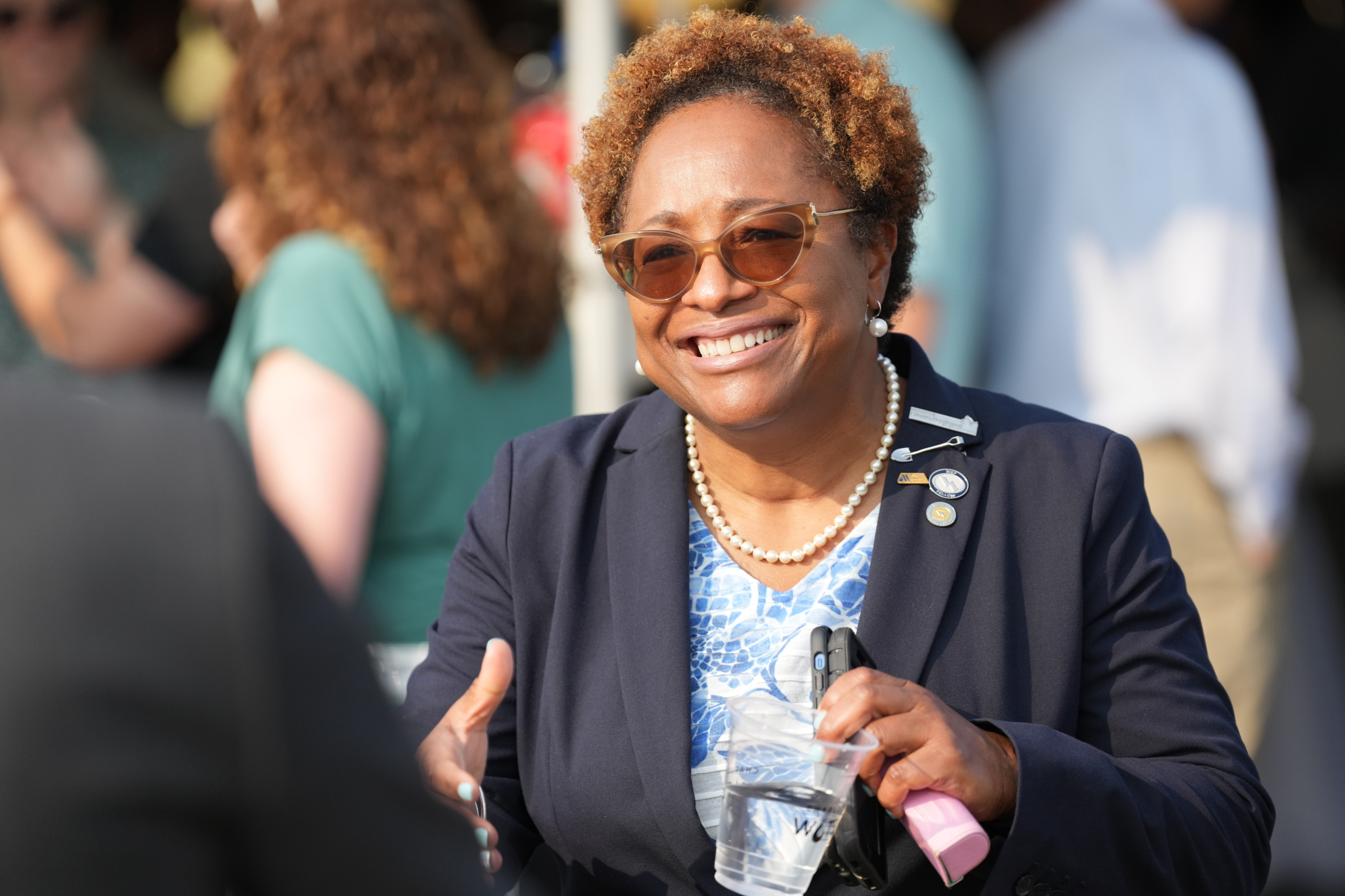 Angela Charles, Charlotte Water Director, smiles and reaches out for a handshake