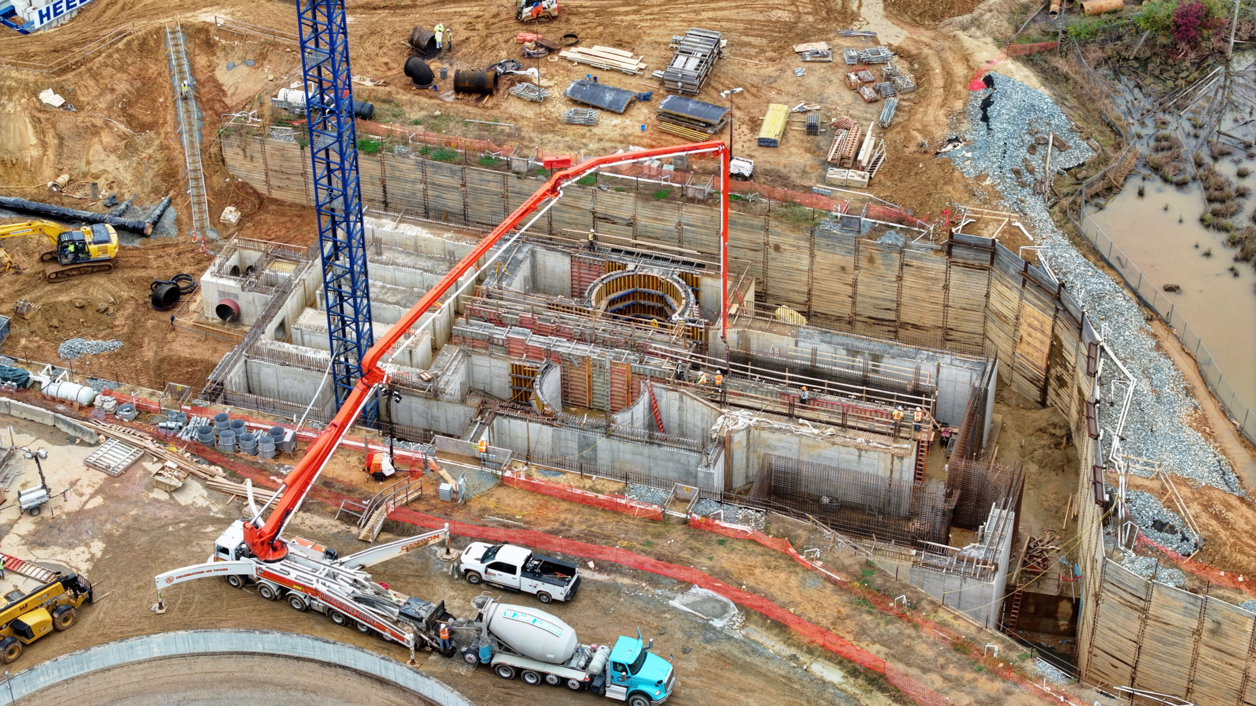 A crane and concrete truck at the construction site.