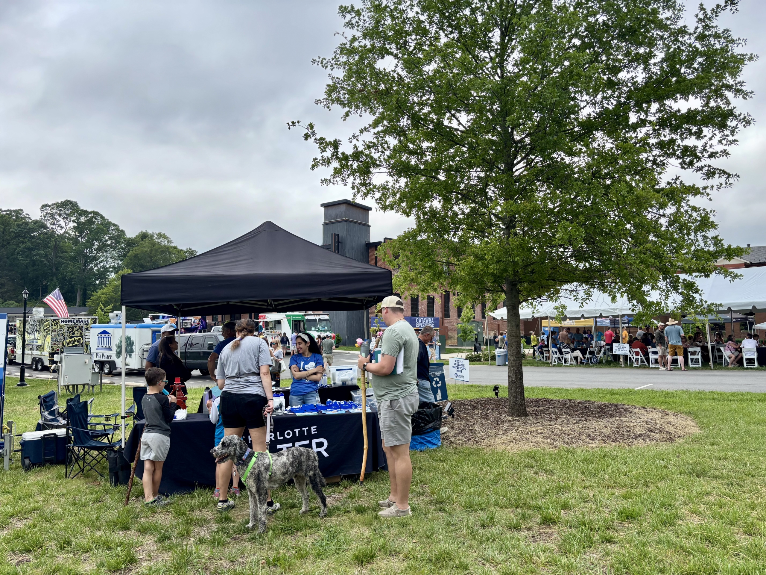 Community members gather around the Charlotte Water tent
