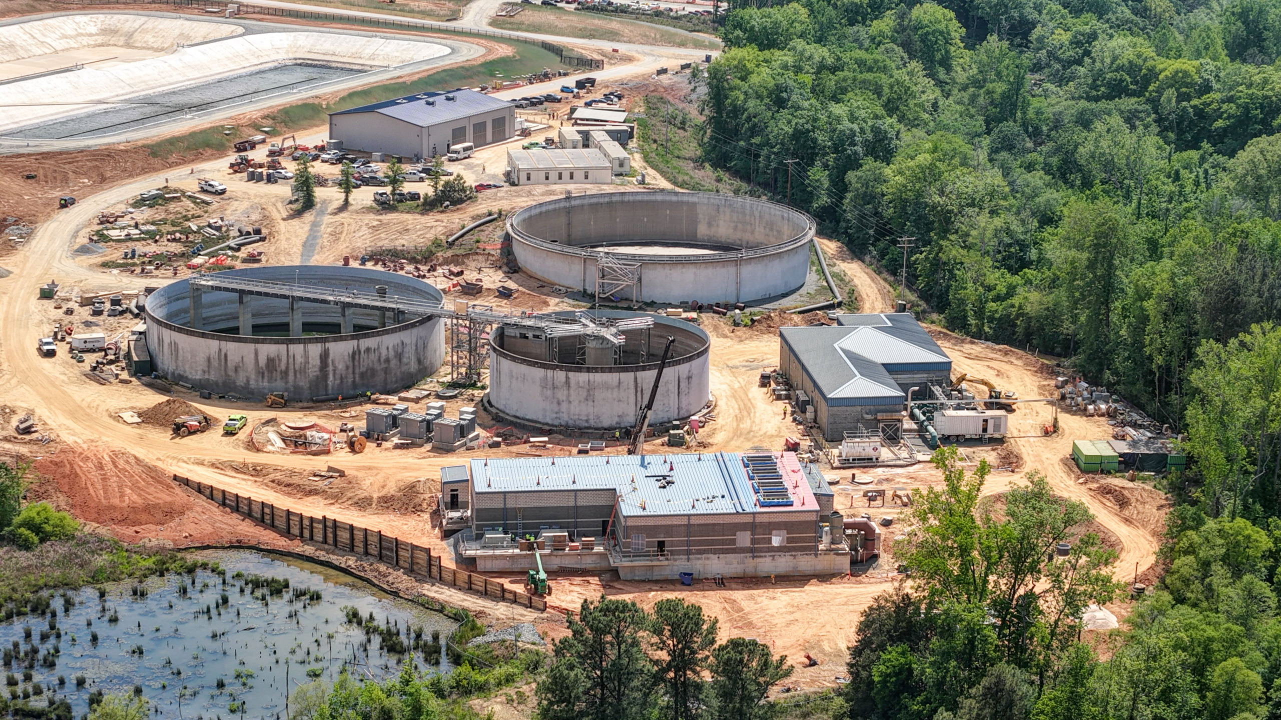 an aerial photograph of several building and large round basins.