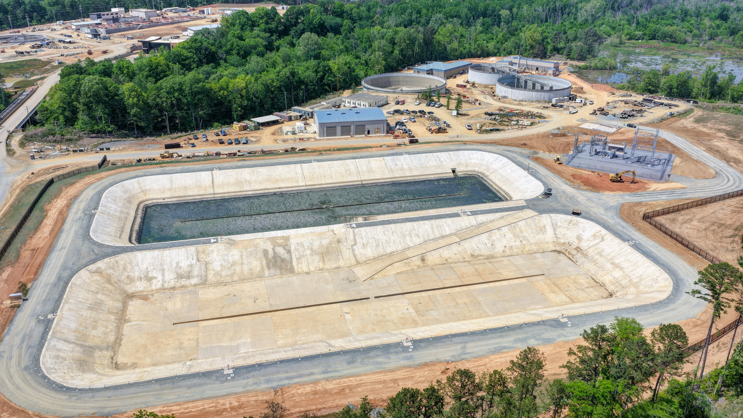 two massive concrete pools that are large enough to hold all the buildings in the background