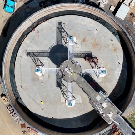 A large circular clarifying tank seen from above
