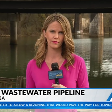 Reporter Robin Kanaday stands in front of the Catawba River reporting on the headline "New Wastewater Pipeline"