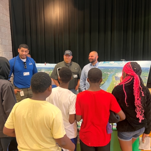 Charlotte Water staff present information boards to a group of students